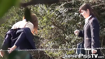 Japanese Schoolgirls Indulge In Naughty Behavior Outdoors, Holding Each Other And Urinating